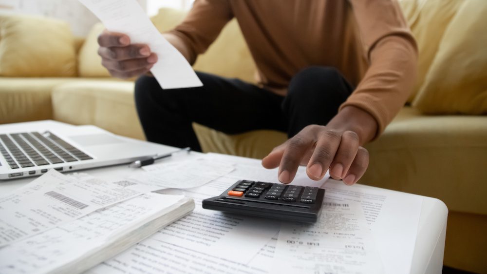 Black small business owner in Arizona calculating his taxes for 2021